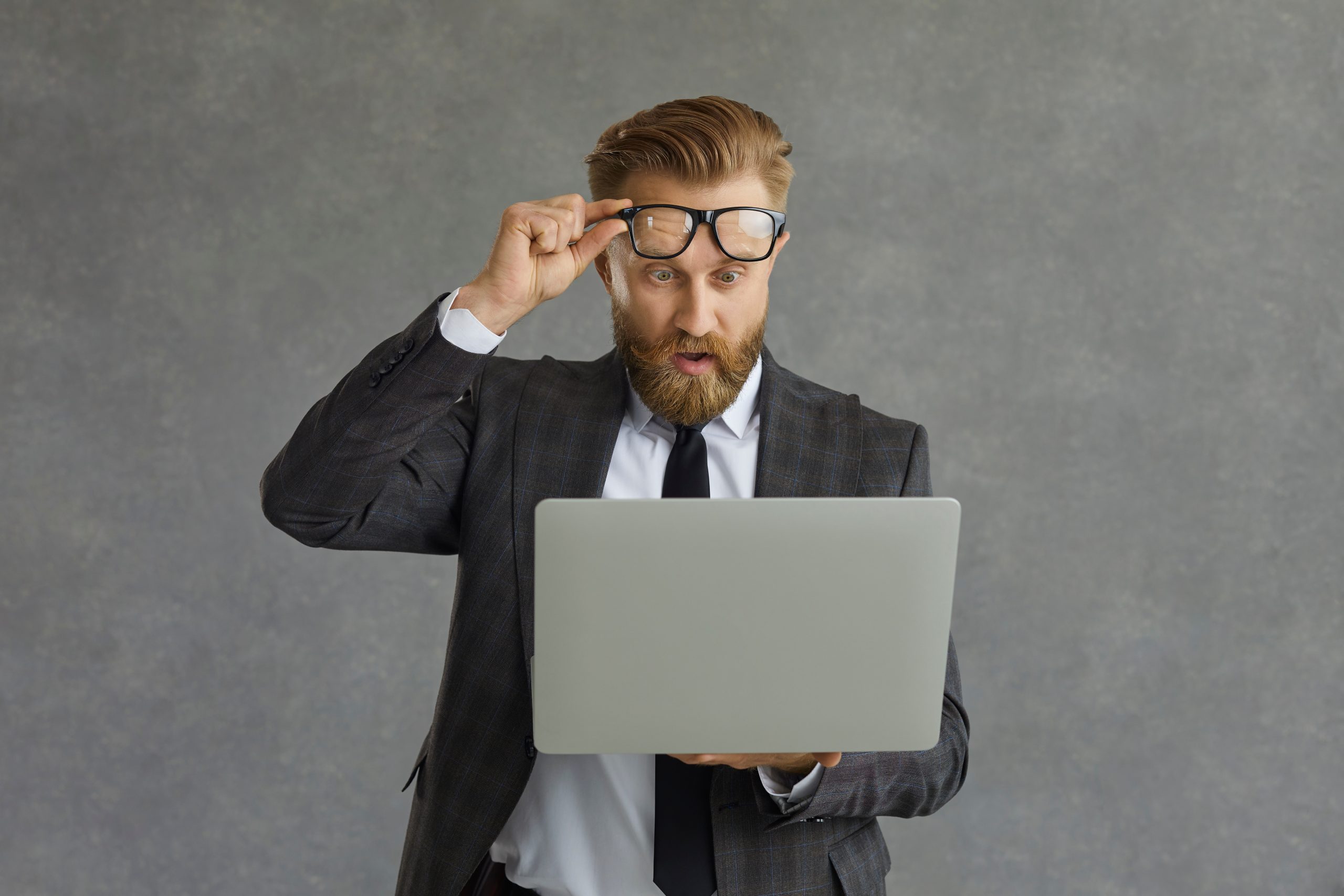 Take off Glasses. Stock Shocked man looking at the Screen.